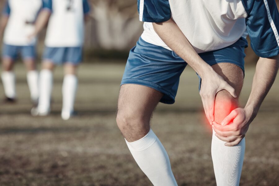 Footballer recovering from knee dislocation through physiotherapy